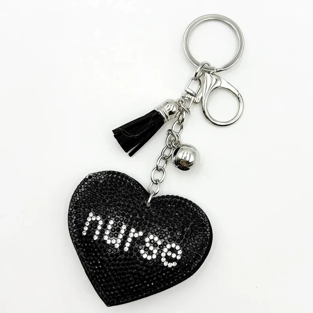 Black rhinestone heart-shaped nurse keychain charm with silver tassel, bell, and lobster clasp on white background