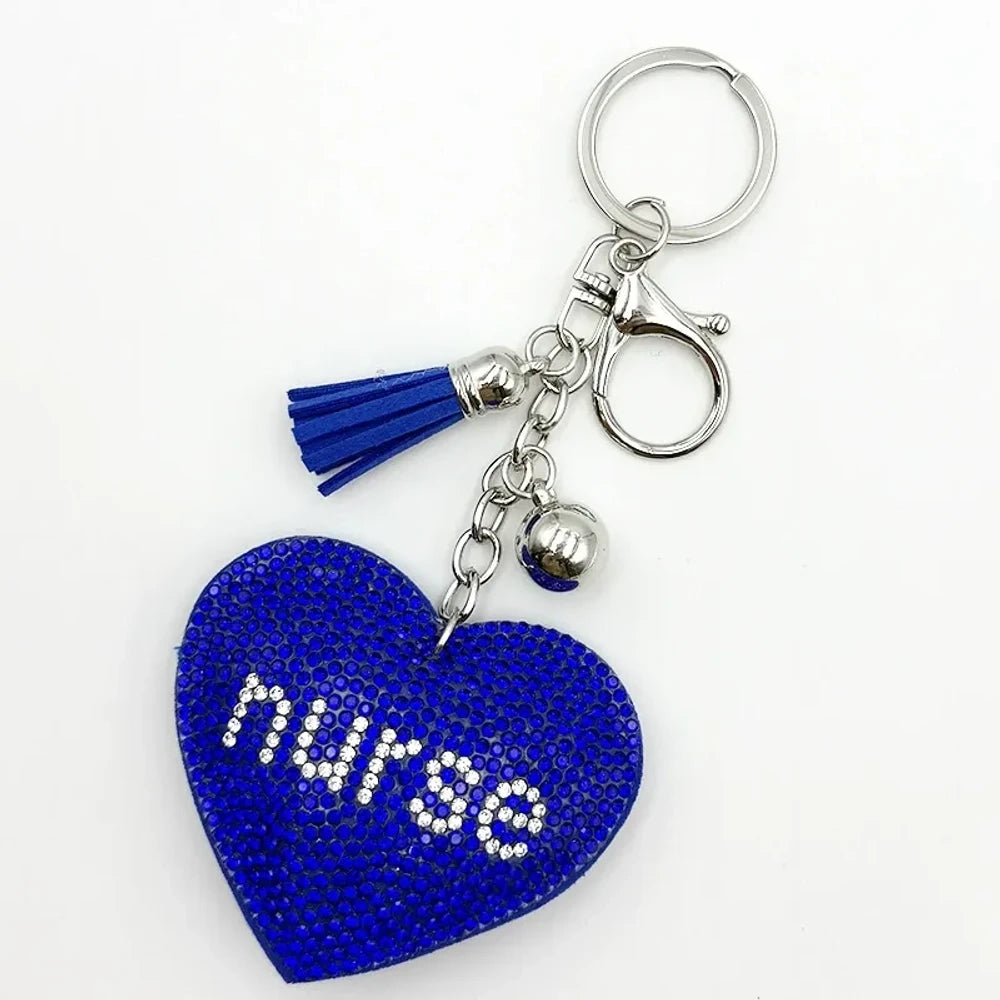 Black rhinestone heart-shaped nurse keychain charm with silver tassel, bell, and lobster clasp on white background - Blue