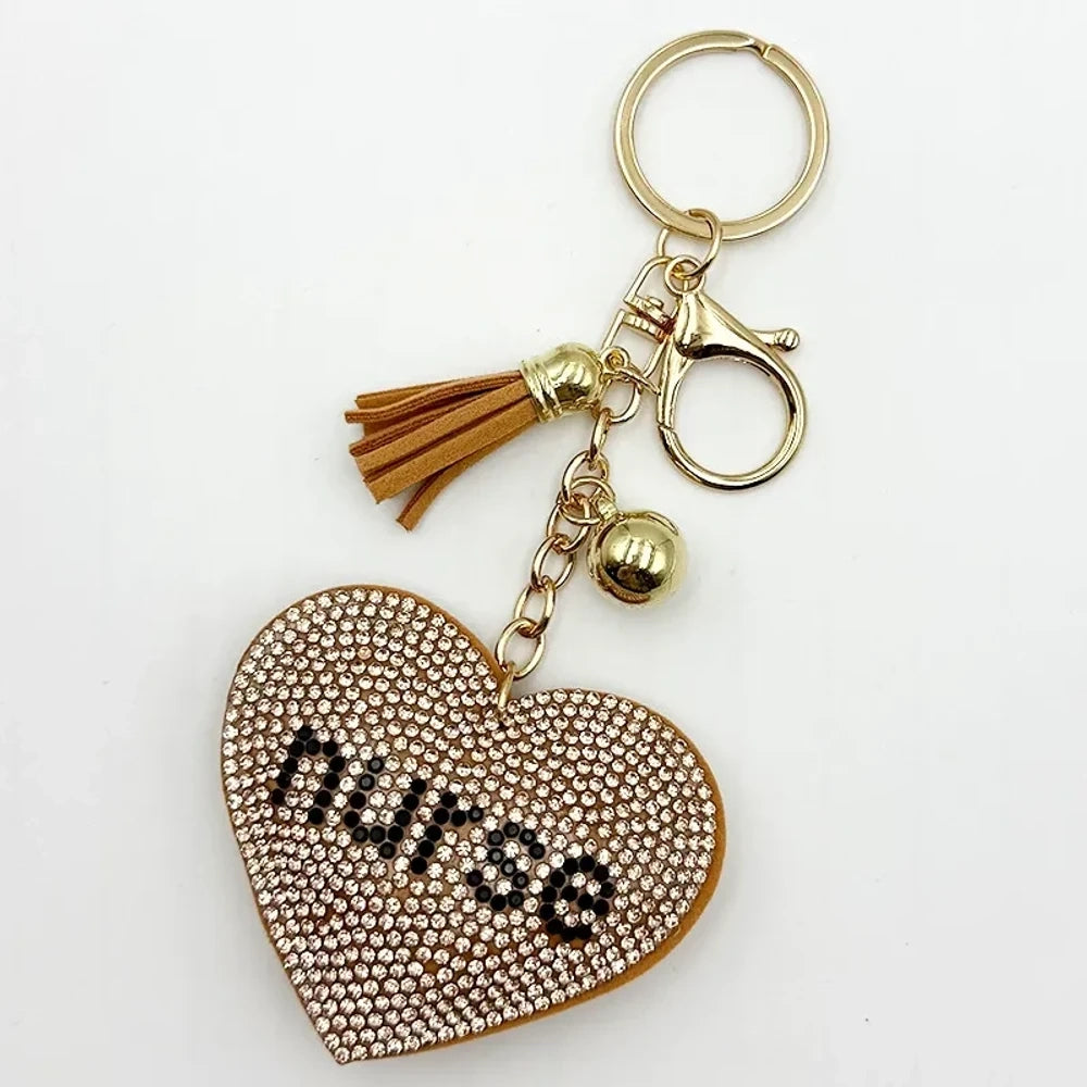 Black rhinestone heart-shaped nurse keychain charm with silver tassel, bell, and lobster clasp on white background - Khaki