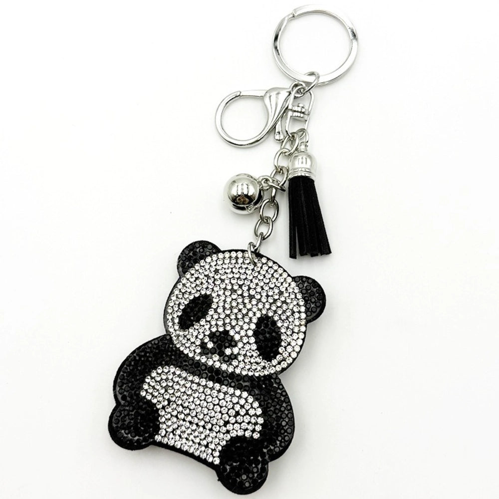 Crystal rhinestone panda bear keychain charm with black and white gemstones, silver ball bead, black tassel, and lobster clasp on white background.