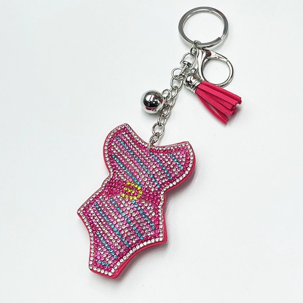 Hot pink rhinestone crystal beaded swimsuit shaped keychain charm with tassel and silver ring on white background
