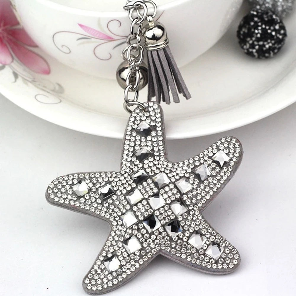 Assorted large rhinestone starfish faux leather fancy beads in black, red, silver, purple, pink, aqua, blue, and white. - Gray