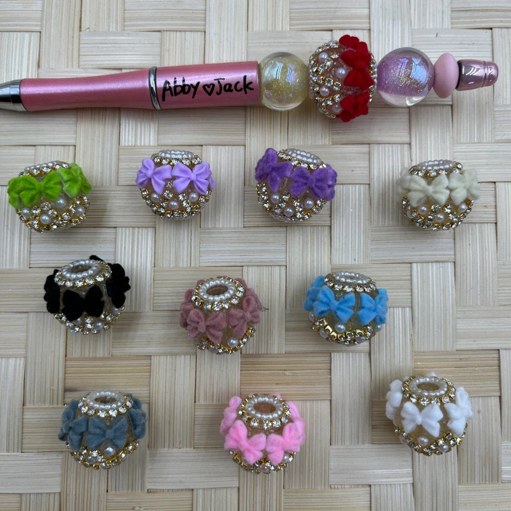 Assorted large hole bow pearl and rhinestone fancy beads in pastel and neutral colors for beadable pens and DIY crafts