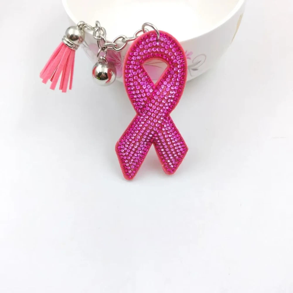Two pink ribbon awareness rhinestone keychain charms on a white background, including a silver heart with pink ribbon and a pink awareness ribbon charm with tassels. - 2