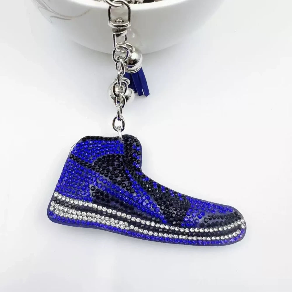Four assorted rhinestone high-top sneaker fancy beads in black, blue, red, and pink keychain style charms on a white background - Blue
