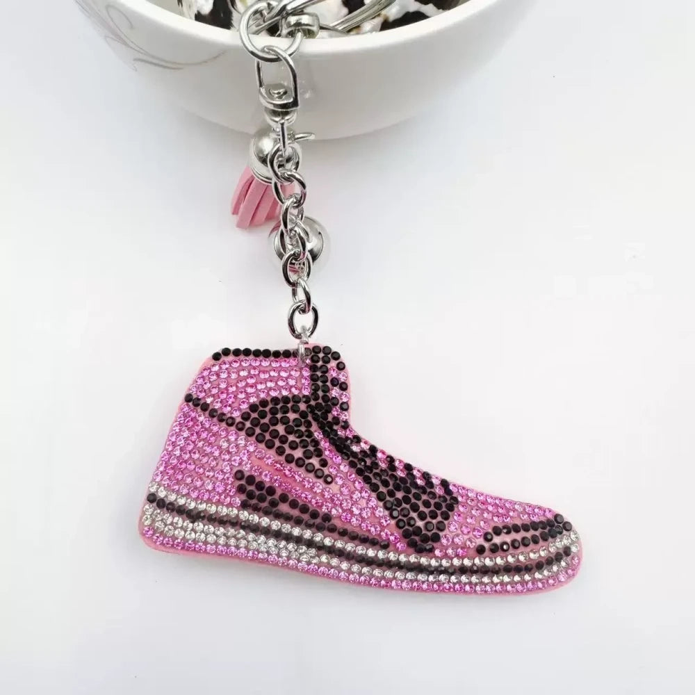 Four assorted rhinestone high-top sneaker fancy beads in black, blue, red, and pink keychain style charms on a white background - Pink
