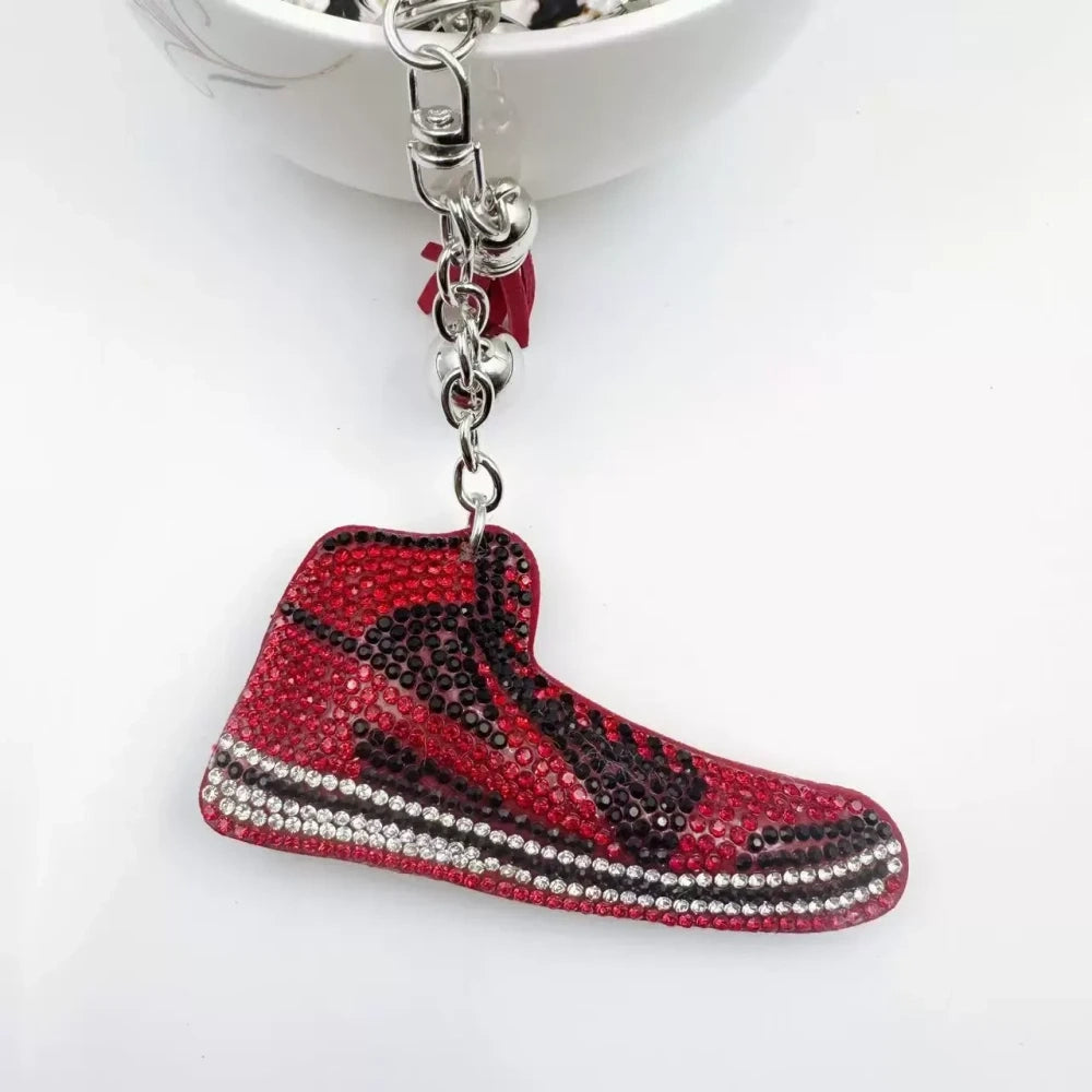 Four assorted rhinestone high-top sneaker fancy beads in black, blue, red, and pink keychain style charms on a white background - Red