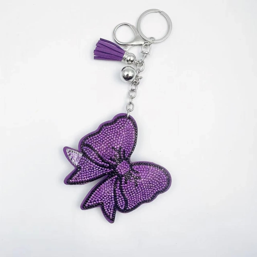 Large bow-shaped rhinestone fancy beads in silver, hot pink, lavender, and lime green on a white background. - Purple