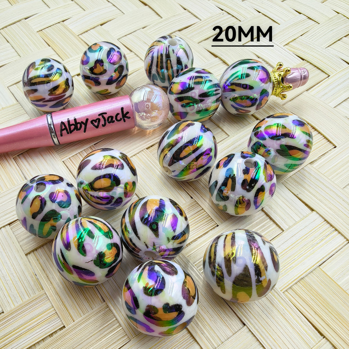 Metallic rose flower ball fancy beads in 7 colors including blue, red, gold, green, dark green, silver, magenta, and purple arranged on woven surface for DIY crafts. - Abby
