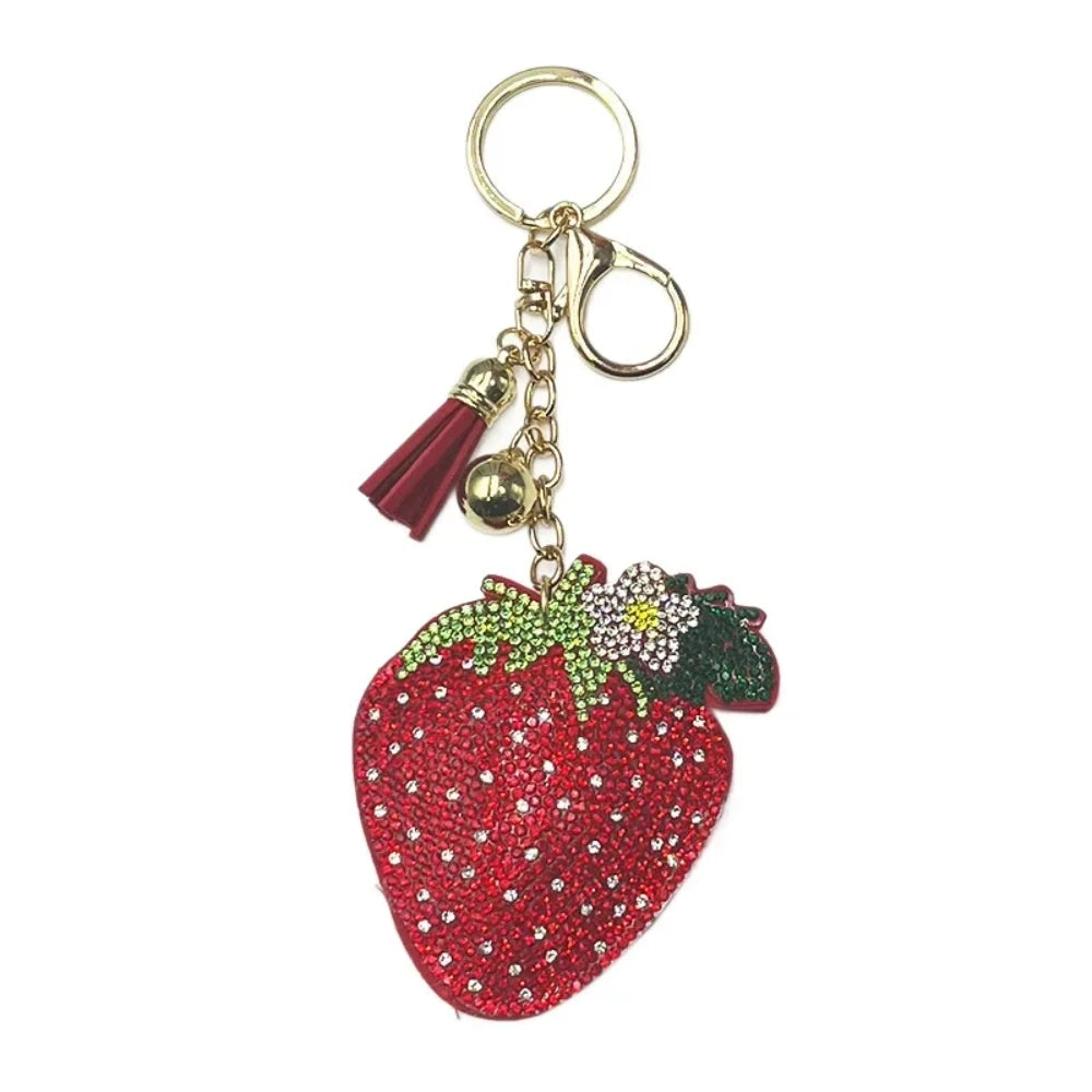 Red strawberry rhinestone fancy bead charm with gold-tone clasp, tassel, bell, flower, and leaf accents