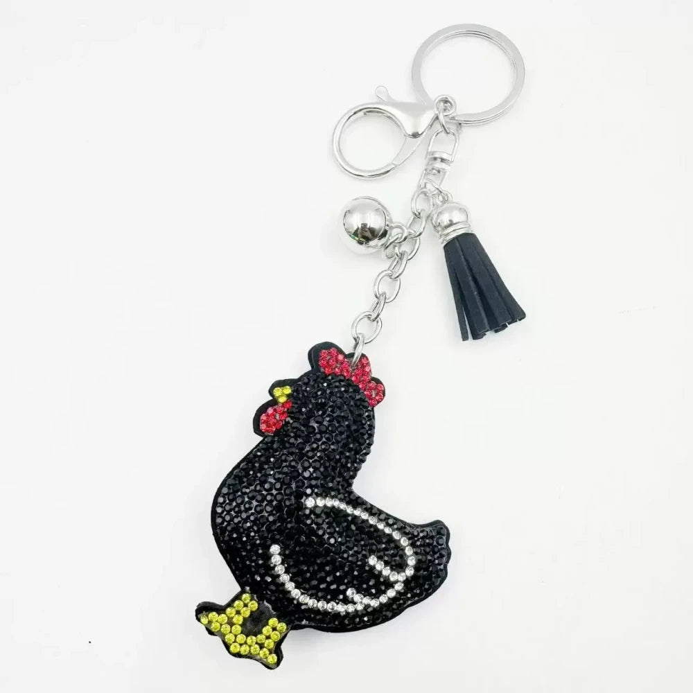 Two white hen rhinestone fancy bead charms with silver keychain rings and tassel accents on white background - Black