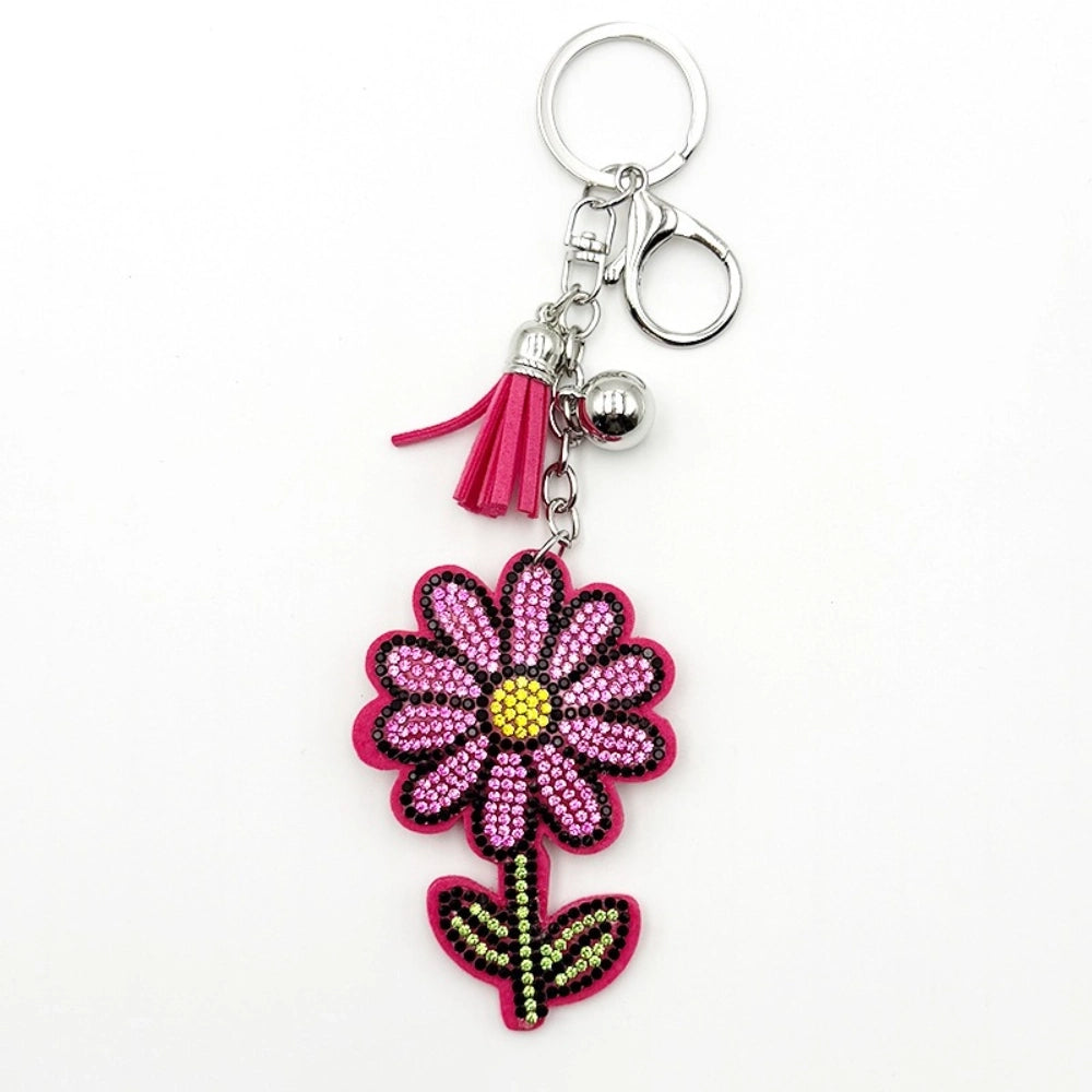 Pink rhinestone flower keychain charm with hot pink tassel, silver bell, and lobster clasp on white background