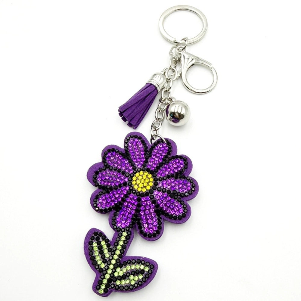 Purple rhinestone daisy flower keychain charm with purple tassel, silver ball, and lobster clasp on white background