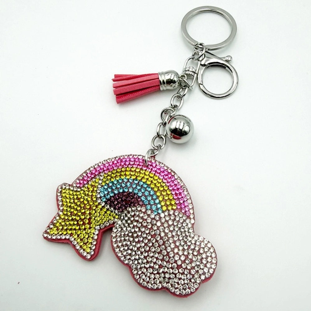 Sparkling rainbow and cloud rhinestone keychain charm with pink leather tassel, silver ball accent, and lobster clasp on silver key ring