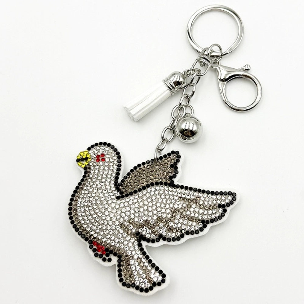 Rhinestone crystal pigeon bird keychain charm with silver lobster clasp, bell, and vial pendant on white background