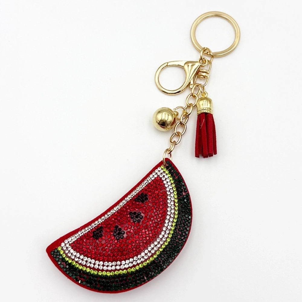 Three rhinestone watermelon slice keychain charms with red tassels, gold beads, and lobster clasp hardware on white background - 1