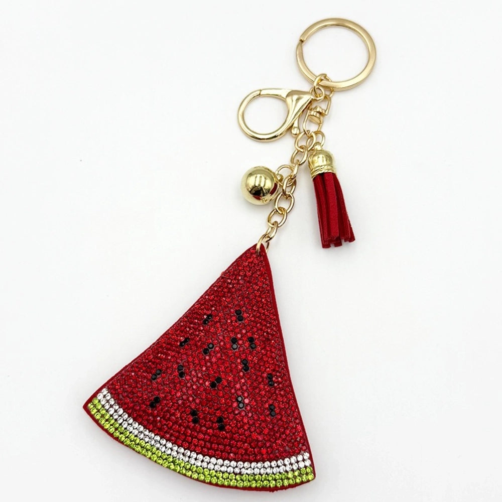 Three rhinestone watermelon slice keychain charms with red tassels, gold beads, and lobster clasp hardware on white background - 3
