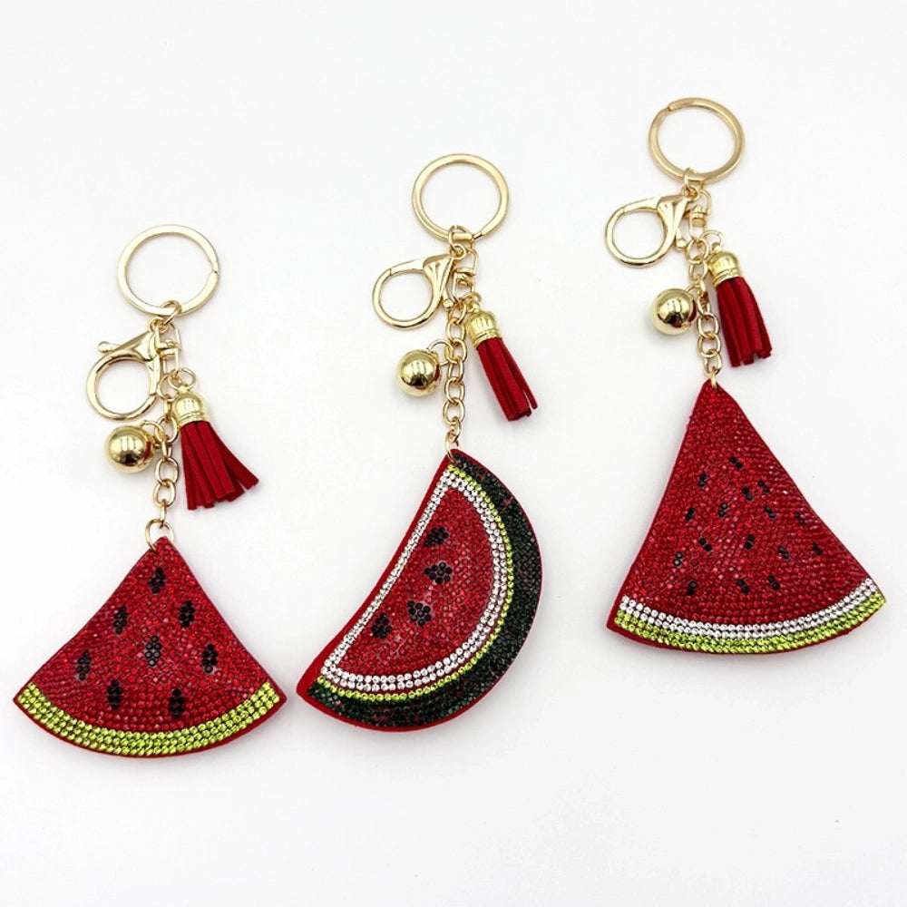 Three rhinestone watermelon slice keychain charms with red tassels, gold beads, and lobster clasp hardware on white background - Random Mixed
