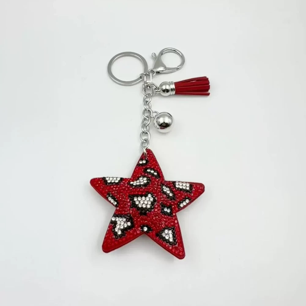 Five star-shaped leopard print rhinestone resin fancy beads in black, red, gold, and silver tones displayed as keychain-style craft pieces. - Red