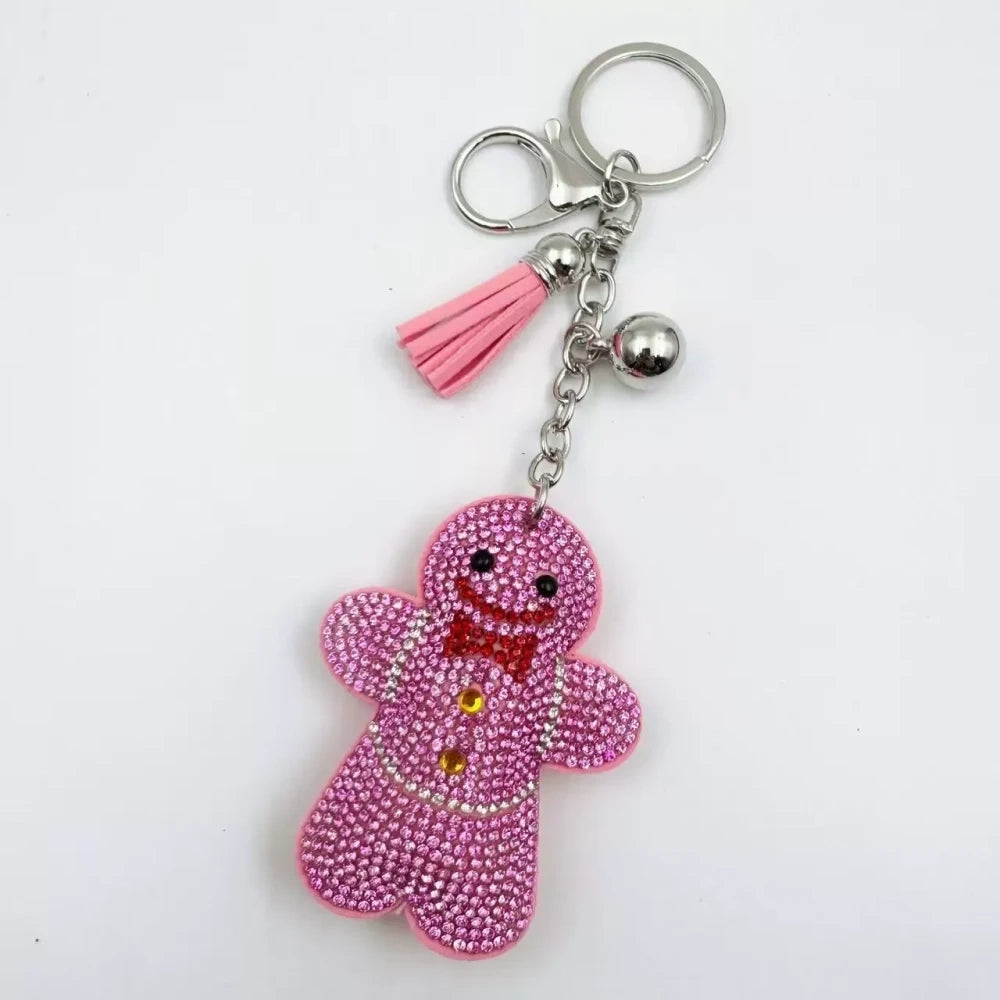 Three rhinestone gingerbread figure keychain charms in brown, pink, and orange with tassels and silver clasp rings - 1