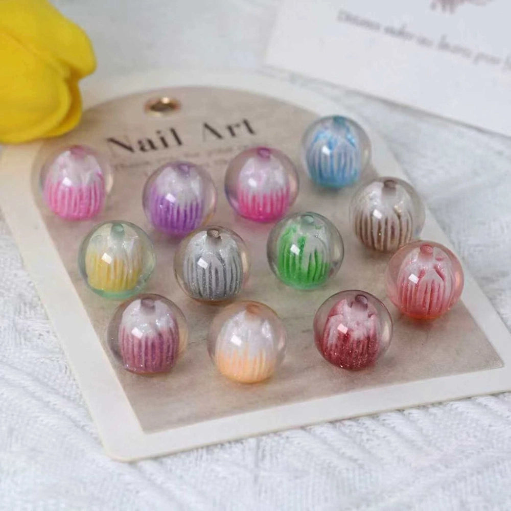 12 gradient glitter globe acrylic beads in assorted colors including pink, purple, blue, green, gray, and red with iridescent inner stripe design displayed on a nail art card