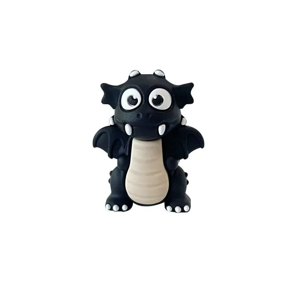 Set of seven 3D cartoon dragon silicone focal beads in black, lime green, dark green, and red colors displayed on and around a miniature white wooden bench against a light green background. - Black
