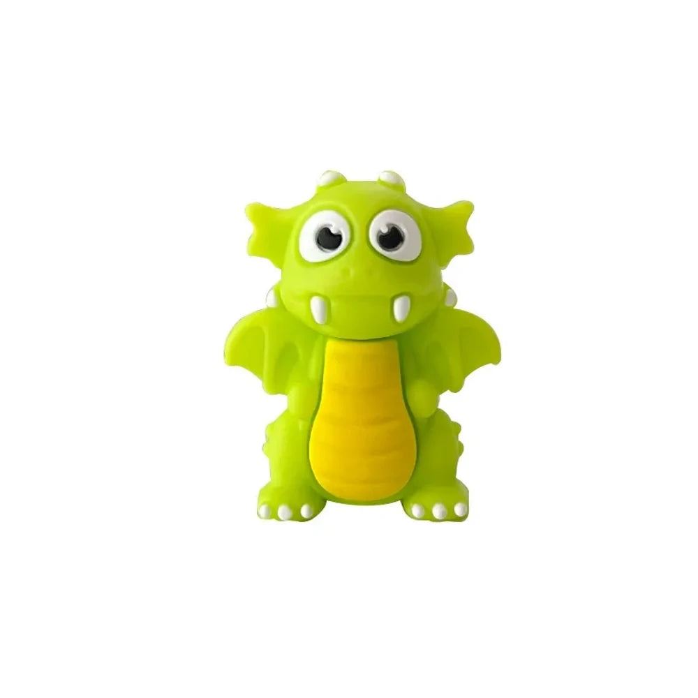Set of seven 3D cartoon dragon silicone focal beads in black, lime green, dark green, and red colors displayed on and around a miniature white wooden bench against a light green background. - Grass Green