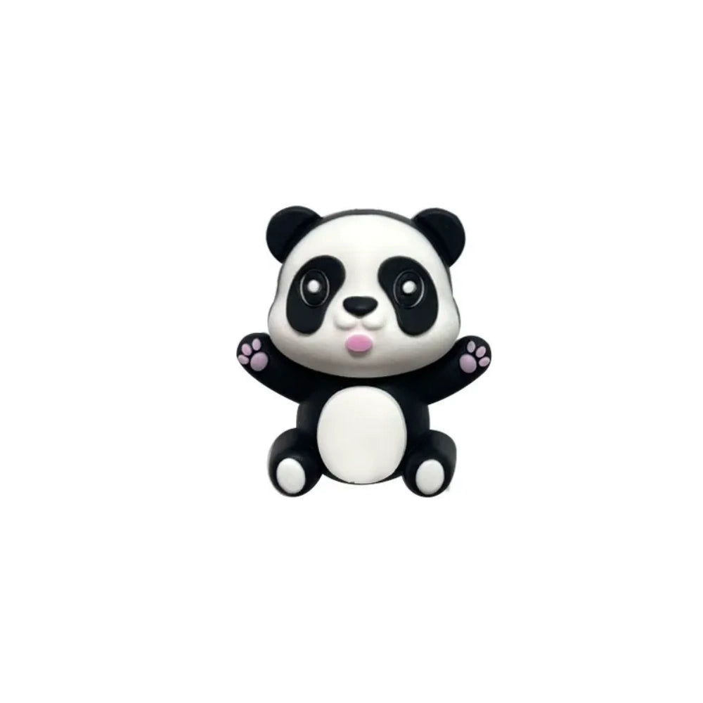 Three 3D panda silicone focal beads in gray, black-and-white, and brown colorways, each sitting on stacked round beads atop black, white, and gold beadable pens against a tan background. - Black