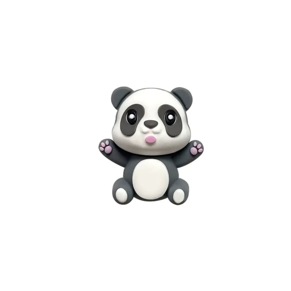 Three 3D panda silicone focal beads in gray, black-and-white, and brown colorways, each sitting on stacked round beads atop black, white, and gold beadable pens against a tan background. - Dark Gray