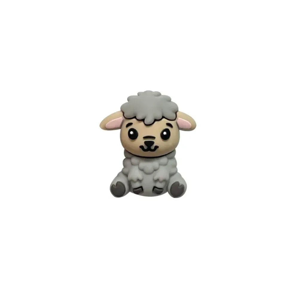 Four cute 3D silicone focal beads shaped like sitting lambs in white, gray, tan, and dark brown colors displayed on a white pedestal against a pink background. - Gray