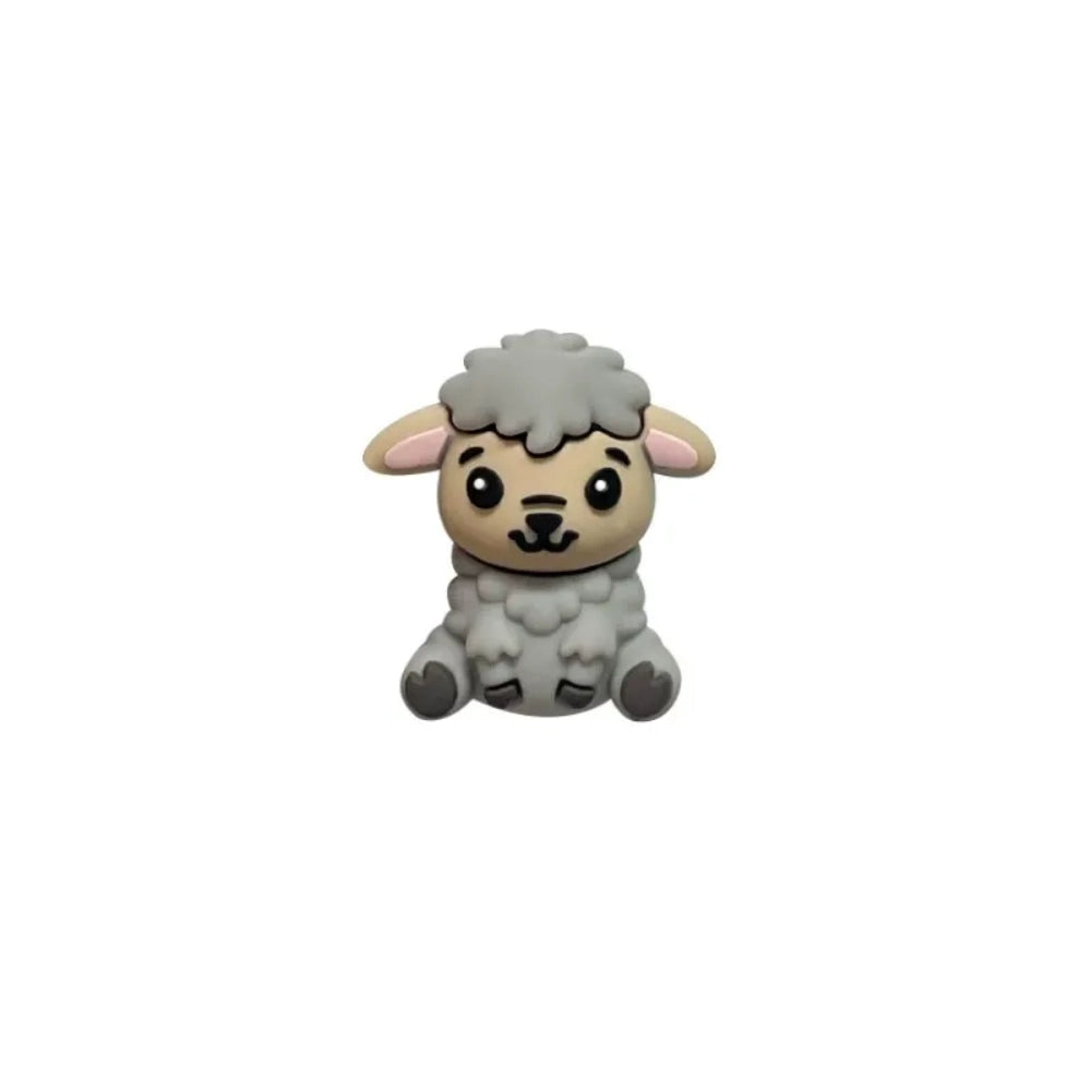 Six miniature 3D silicone focal beads shaped like cute sitting lambs in brown, tan, grey, and white colorways displayed on a white platform with pink flowers on a mauve background. - Gray