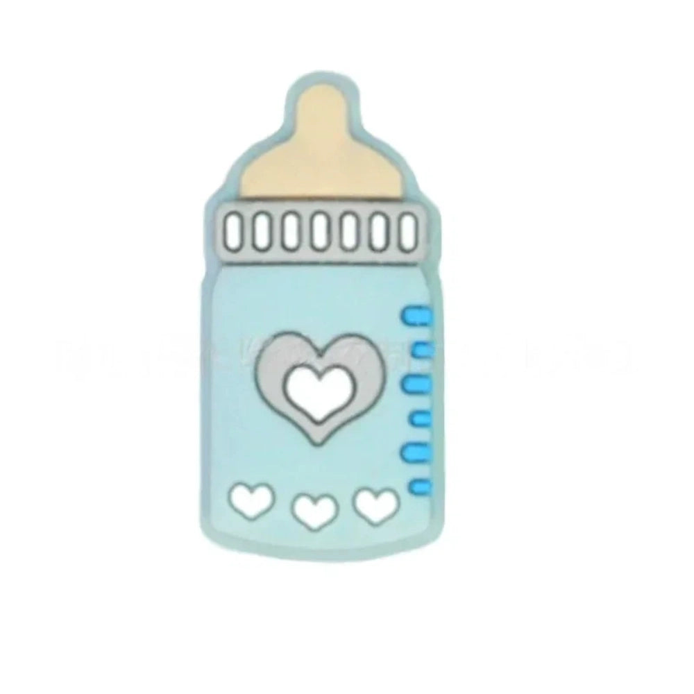 Assorted pastel silicone baby bottle flatback focal beads with heart designs in purple, teal, blue, gray, and pink on a mint background. - 1