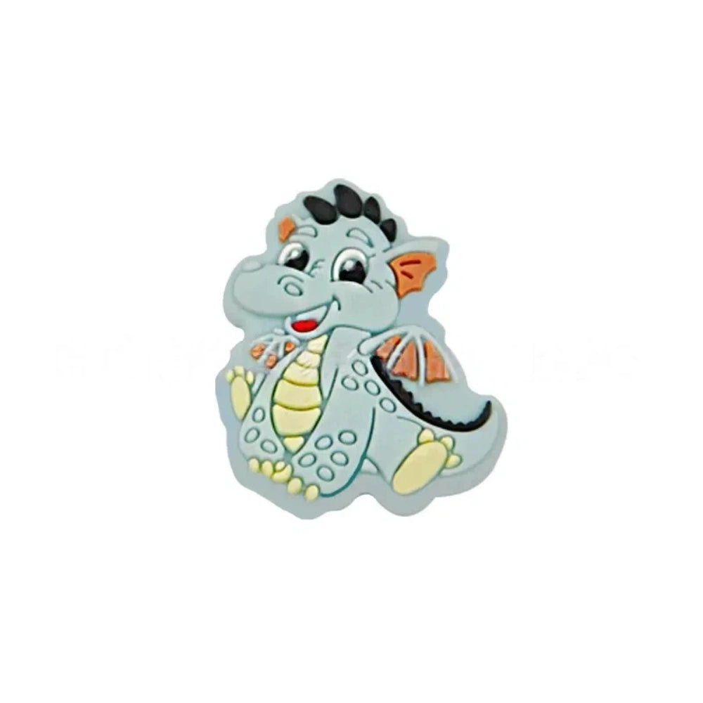 Six colorful baby dragon silicone focal beads in mint, blue, pink, green, lime, and purple displayed on white risers, featuring heart cutout belly and wing details for DIY craft projects. - Blue