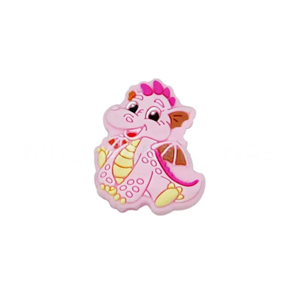 Six colorful baby dragon silicone focal beads in mint, blue, pink, green, lime, and purple displayed on white risers, featuring heart cutout belly and wing details for DIY craft projects. - Pink