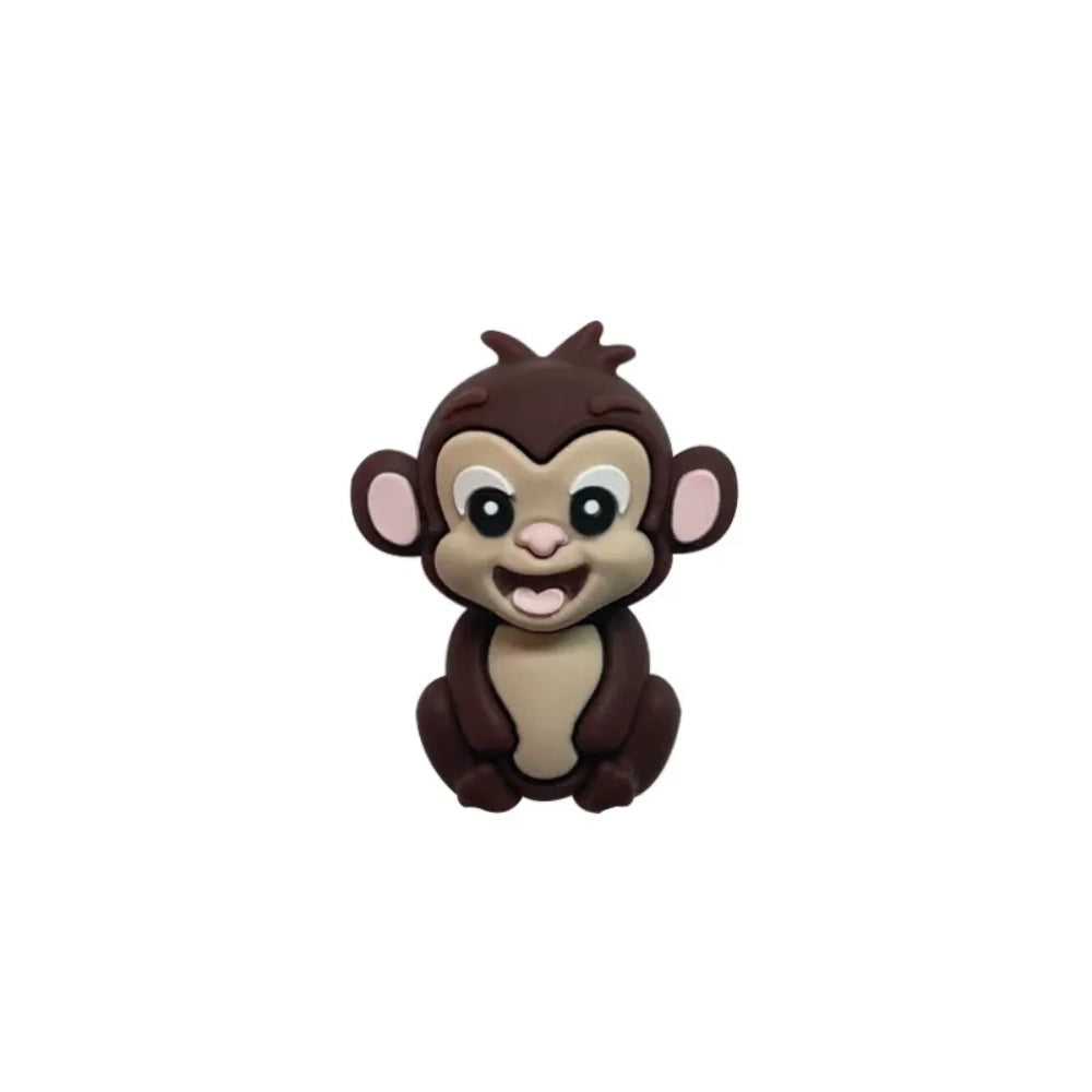 Set of 7 colorful baby monkey 3D silicone focal beads in brown, dark brown, yellow, pink, orange, rust, and purple displayed on a white pedestal with yellow background. - 2