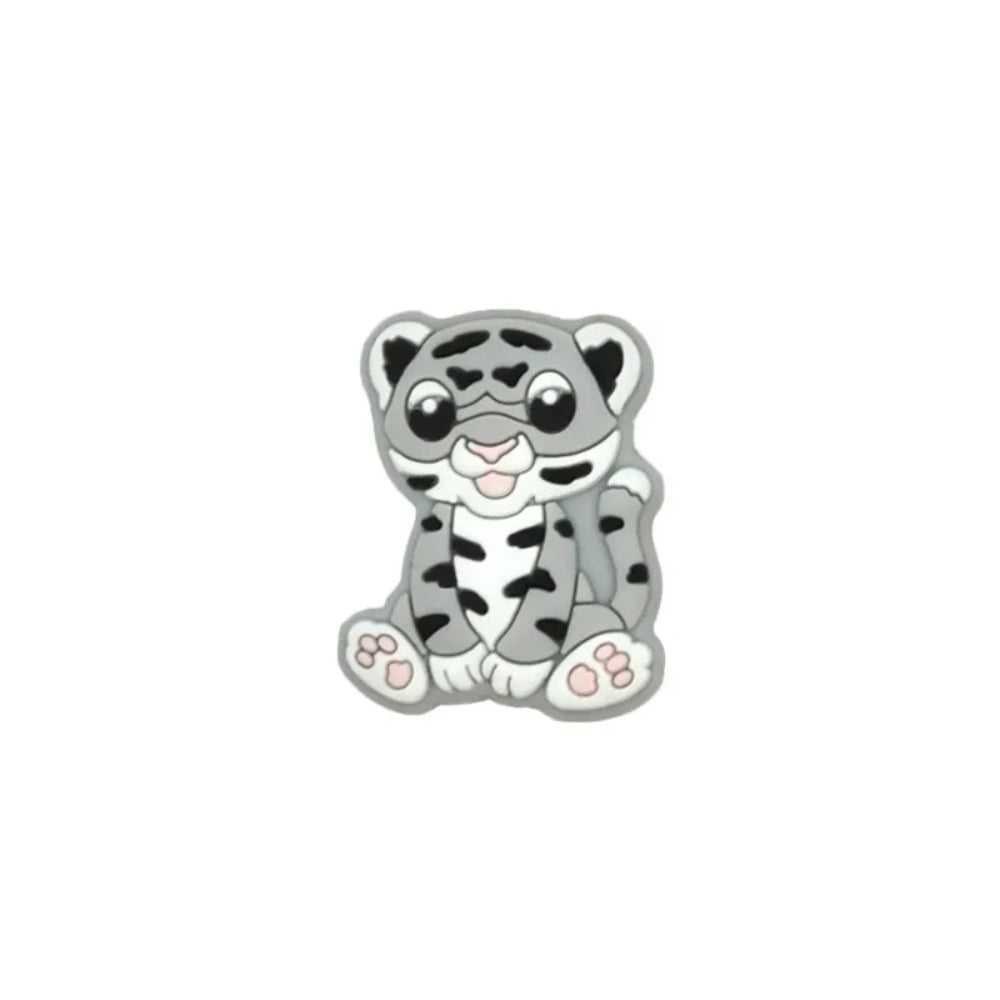 Seven colorful baby tiger silicone focal beads in yellow, brown, gray, orange, pink, white, and mint displayed on a miniature white bench against a teal background. - 2