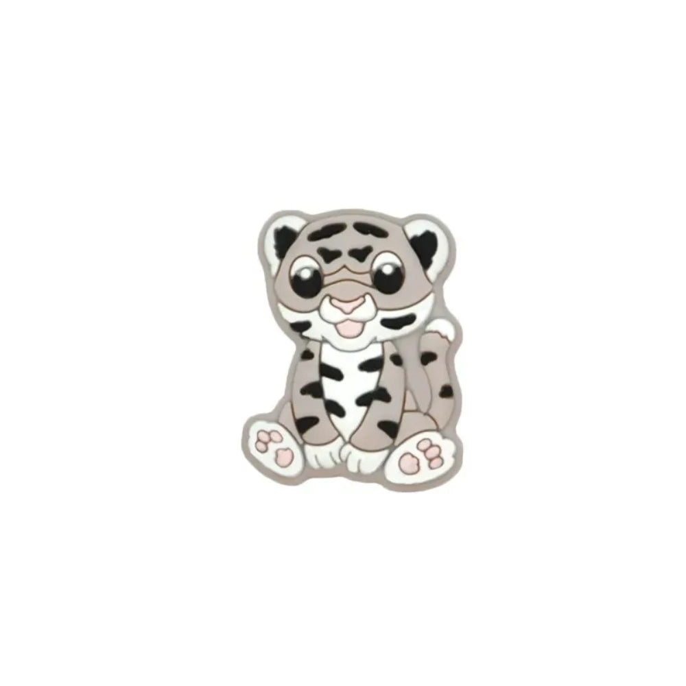 Seven colorful baby tiger silicone focal beads in yellow, brown, gray, orange, pink, white, and mint displayed on a miniature white bench against a teal background. - 7