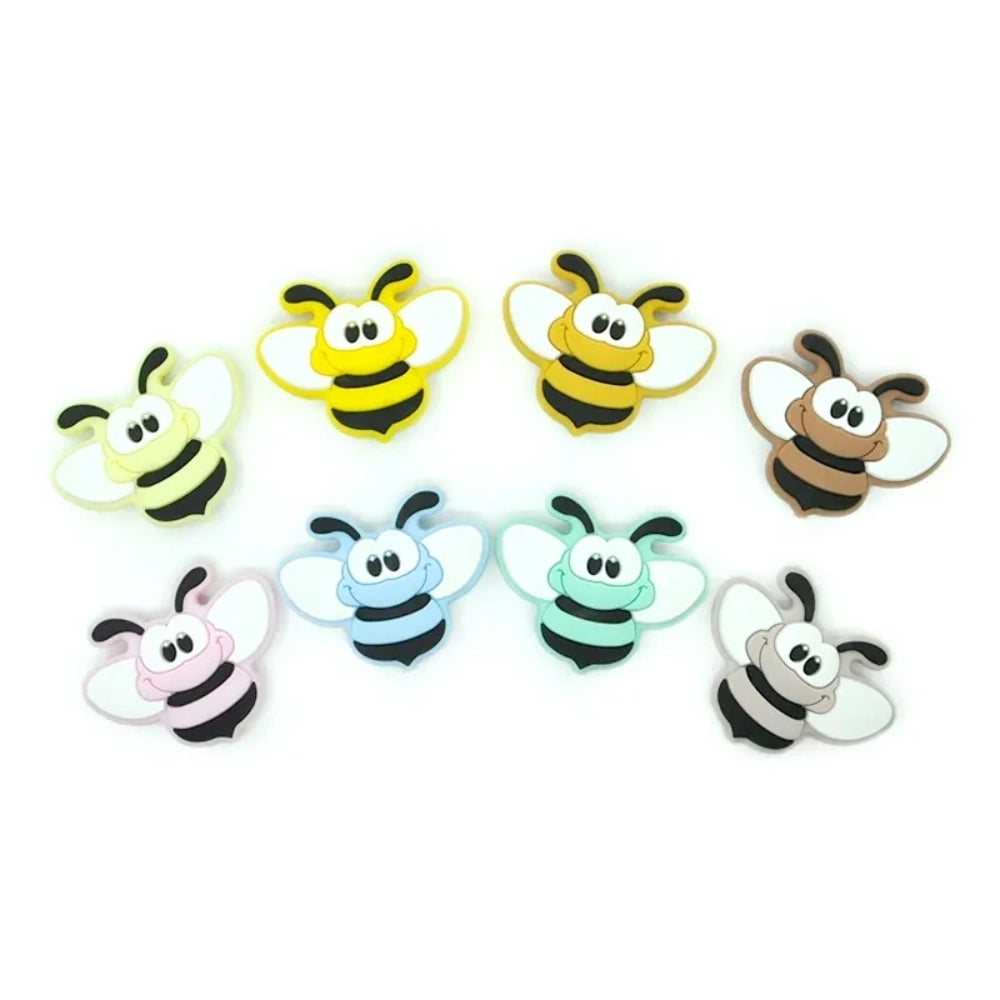 Set of 8 cartoon bumble bee silicone focal beads in assorted colors including yellow, gold, pink, blue, mint, brown, and gray on white background.