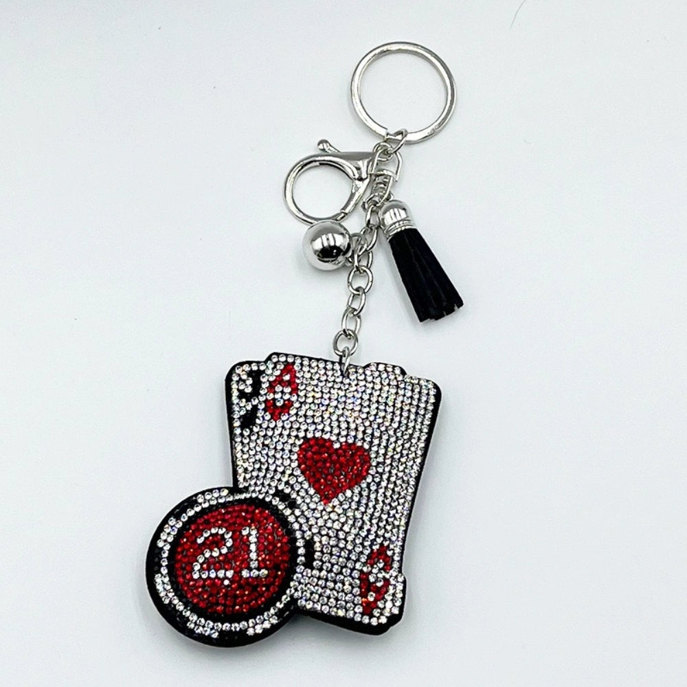 Rhinestone-encrusted casino playing cards and poker chip keychain charm with red crystal heart, black tassel, and silver lobster clasp hardware