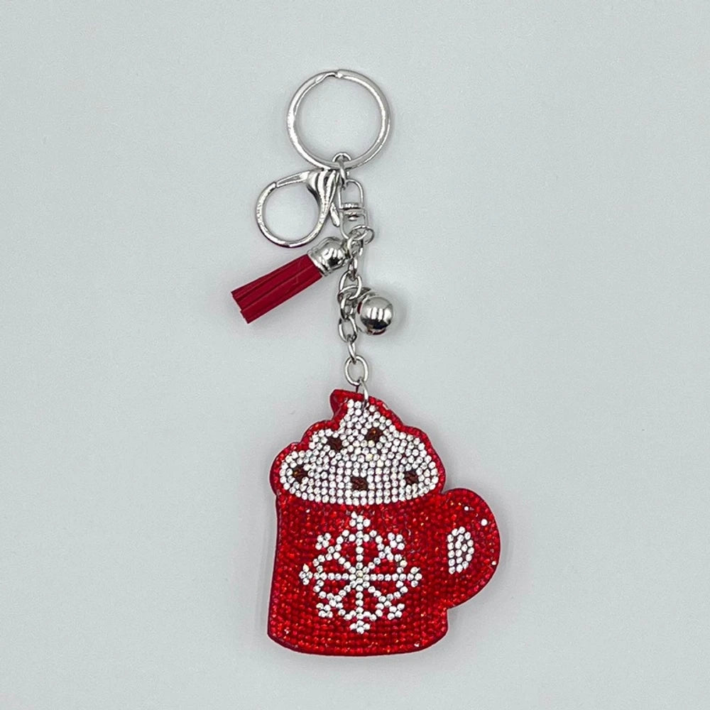 Set of 6 Christmas diamond painting keychains featuring Santa Claus, reindeer, Christmas tree, star, jingle bells, and mitten designs with tassels and jingle bell charms on silver and gold rings. - Hot Cocoa