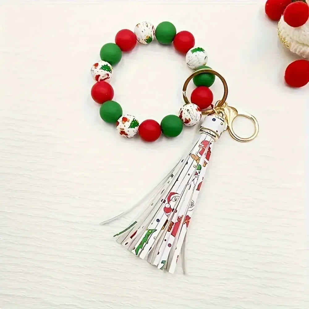 Christmas holiday printed silicone beads in red, green, and white with snowflake and Santa patterns, shown on beaded bracelet keychain wristlets with tassels. - 3