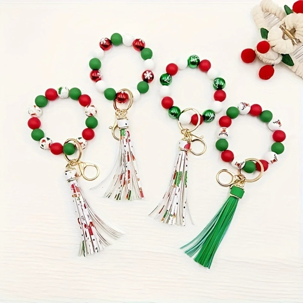 Christmas holiday printed silicone beads in red, green, and white with snowflake and Santa patterns, shown on beaded bracelet keychain wristlets with tassels. - Random Mixed