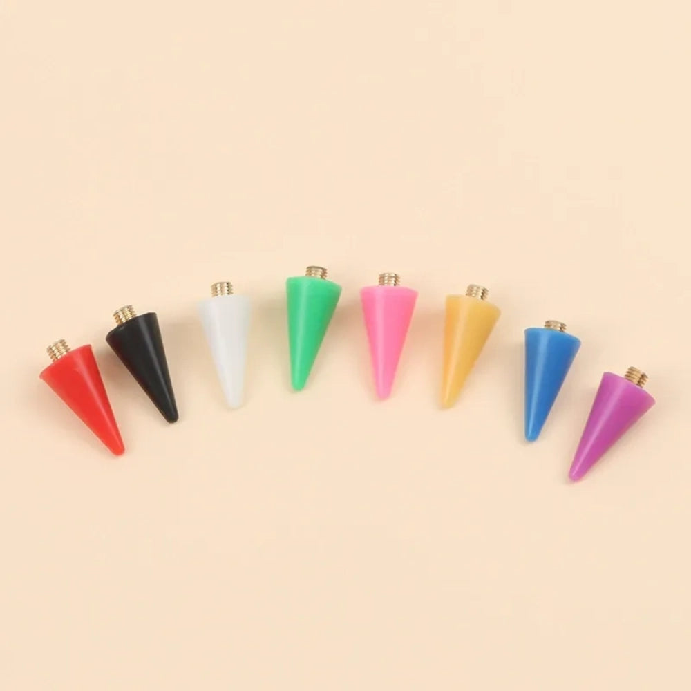 Eight colorful acrylic spike cone fancy beads with gold screw tops arranged in a curved row, in red, black, white, green, pink, yellow, blue, and purple, on a peach background.