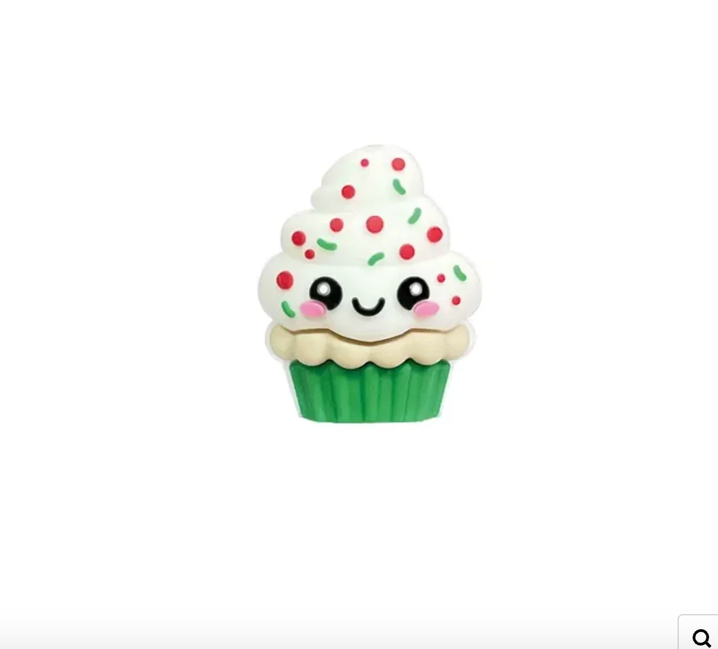 Kawaii cupcake 3D silicone focal beads with sprinkles and smiley faces displayed on colorful beadable pens against a pink background, available at DIY Mini Planet. - Green