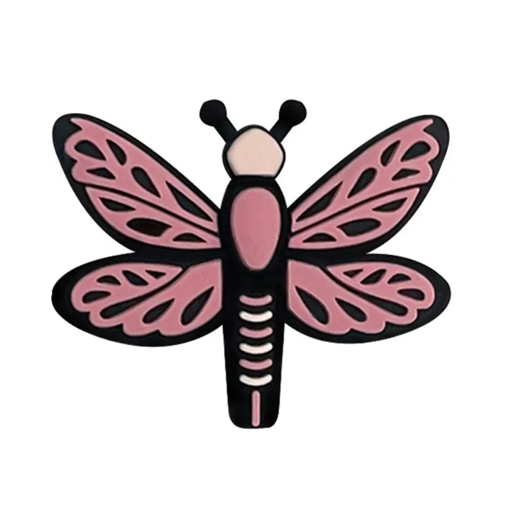 Seven colorful dragonfly silicone focal beads in pink, hot pink, and blue shades arranged on a pink background, featuring detailed wing patterns and black outlines. - Red