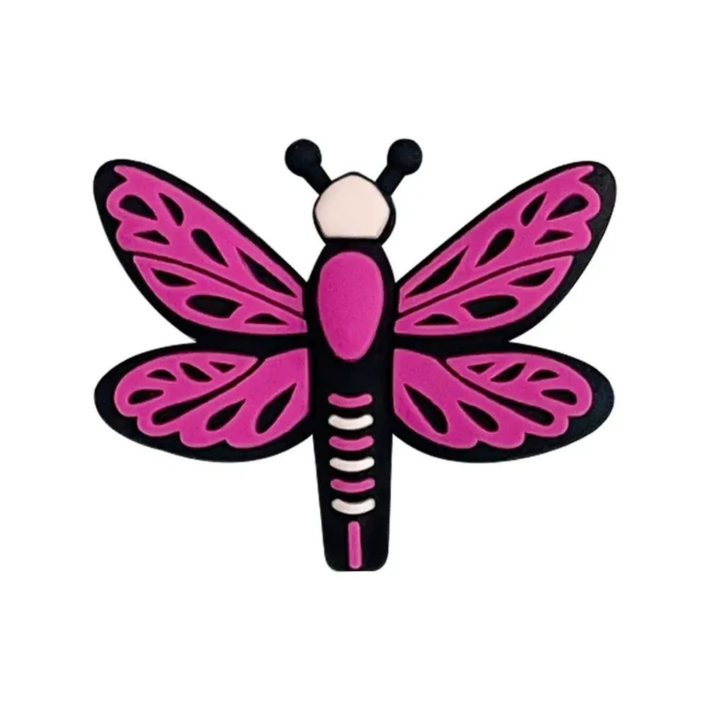 Seven colorful dragonfly silicone focal beads in pink, hot pink, light blue, and teal arranged on a pink background, featuring lace-pattern wings and black outlines. - Purple-Red