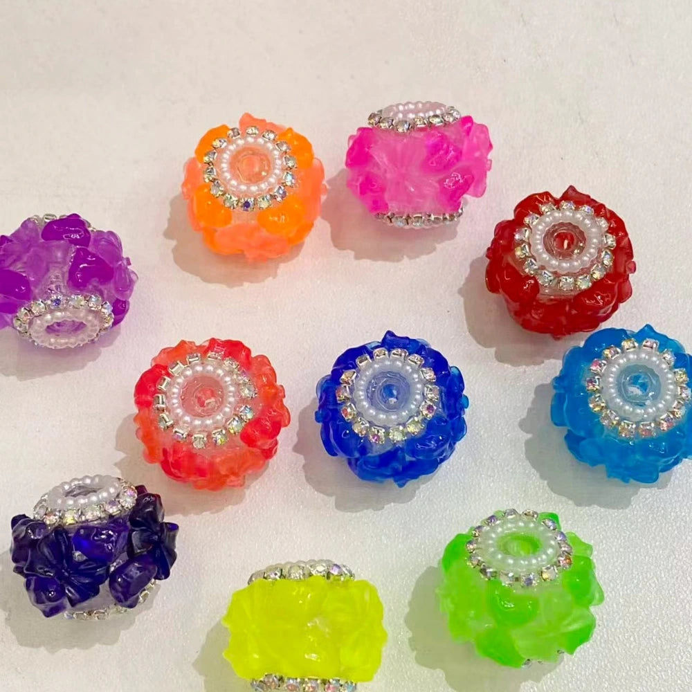 Assorted neon and jewel-tone floral resin fancy beads with rhinestone and pearl center embellishments in purple, orange, pink, red, blue, green, and yellow