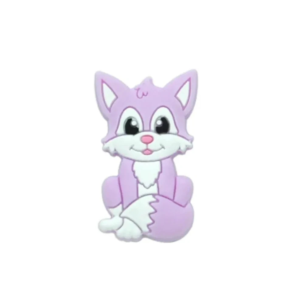Eight cartoon fox silicone focal beads in assorted colors including gray, green, peach, blue, purple, pink, tan, and orange, featuring smiling faces and white chest details. - Purple