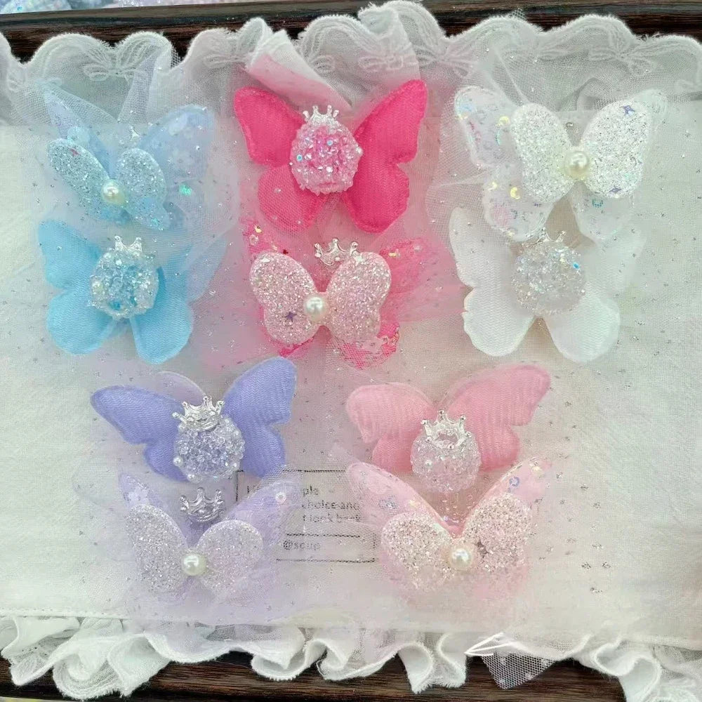 Assorted pastel glitter butterfly fancy beads with crown and pearl embellishments in blue, pink, white, purple colors for DIY jewelry making and beadable pens.