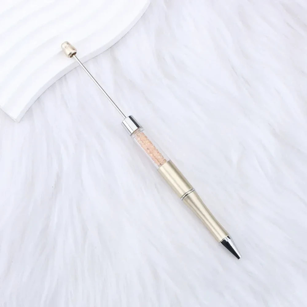 25-piece set of multicolor glitter crystal beadable plastic pens with silver accents and bead bar tops, arranged in a fan display on white fabric - 15